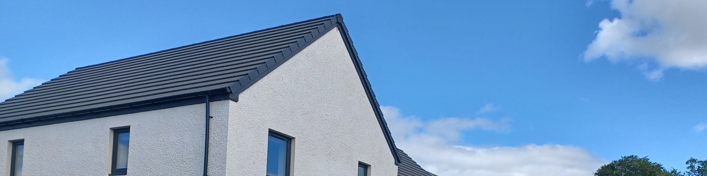 Image of a house roof and blue sky